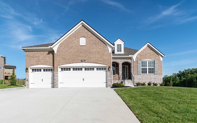7938 Pine St, Fairview, TN 37062 - view of front of property featuring concrete driveway, a front yard, stone siding, a garage, and brick siding