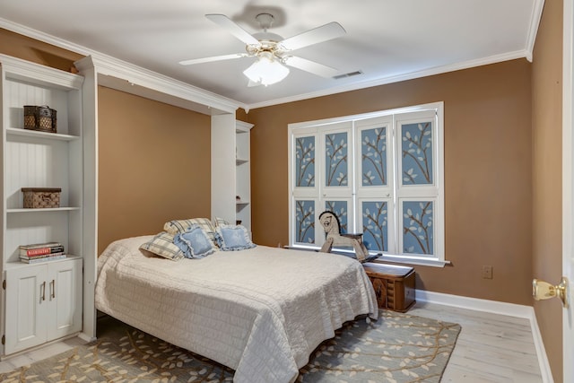 bedroom featuring ceiling fan, light hardwood / wood-style flooring, and ornamental molding