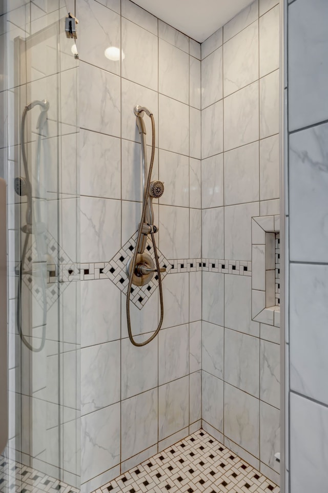 bathroom with a tile shower