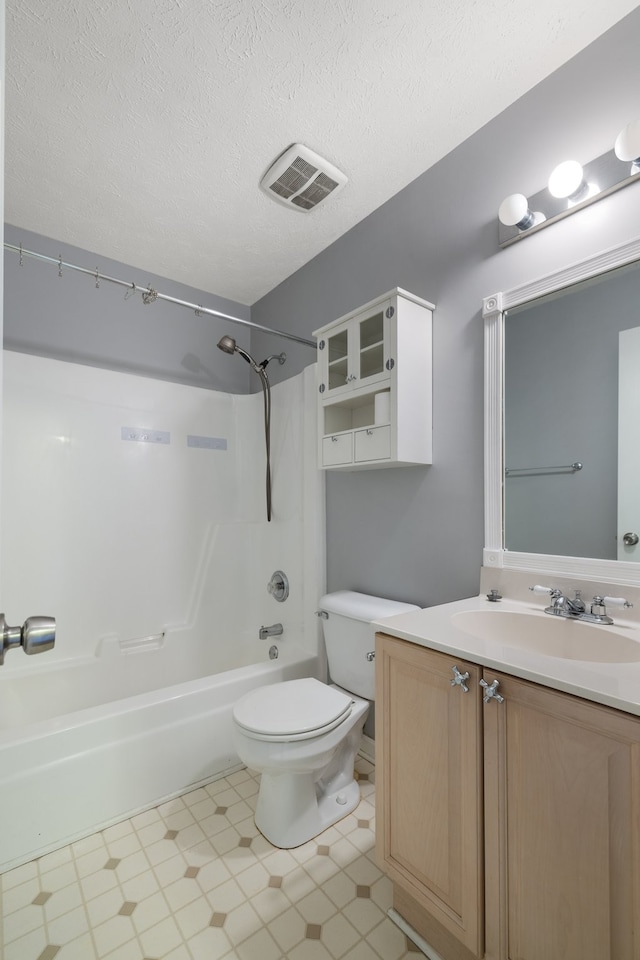 full bathroom with vanity, toilet, a textured ceiling, and bathtub / shower combination