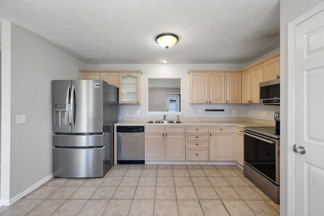 kitchen featuring sink, stainless steel appliances, a textured ceiling, light brown cabinetry, and light tile patterned flooring