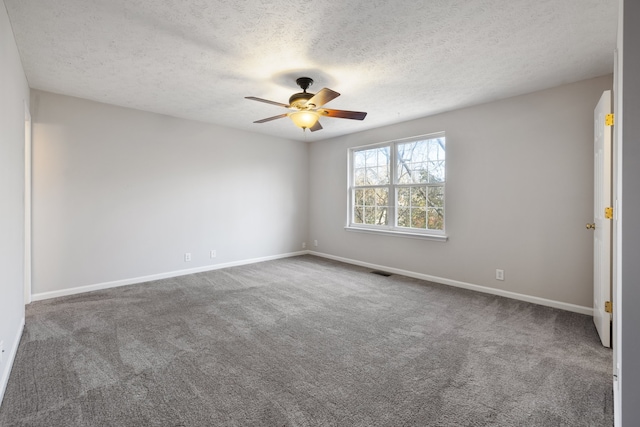 carpeted spare room with ceiling fan and a textured ceiling