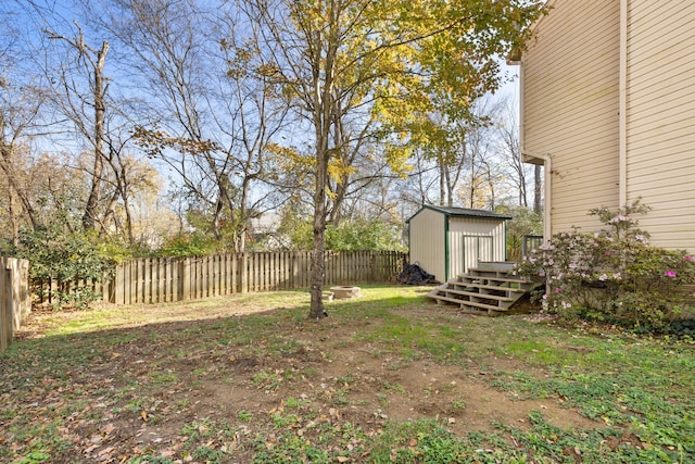 view of yard featuring a wooden deck and a shed