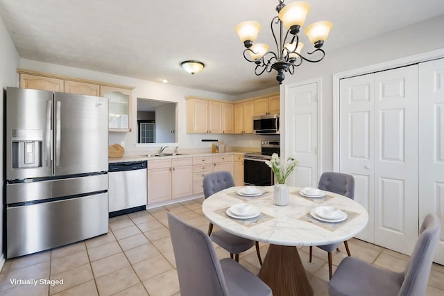 kitchen featuring a chandelier, light brown cabinetry, stainless steel appliances, and sink