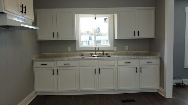 kitchen featuring white cabinetry, dark wood-type flooring, and sink