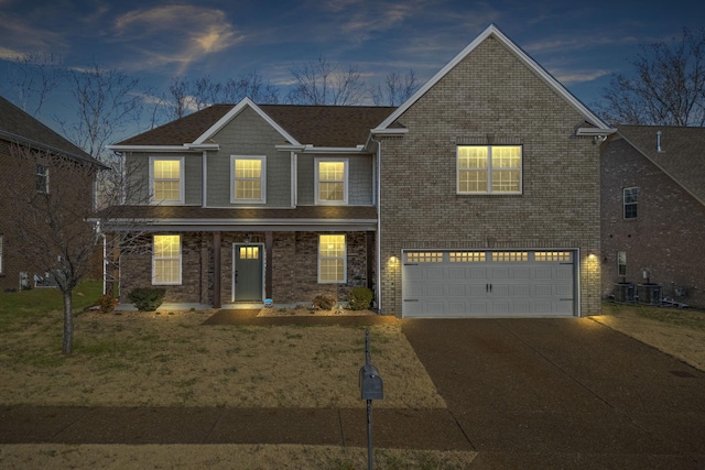 front facade with a garage and central air condition unit