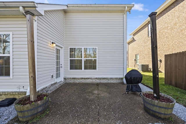 rear view of property with central AC and a patio