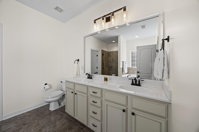 bathroom featuring a tile shower, tile patterned flooring, vanity, and toilet