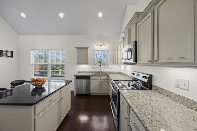 kitchen featuring gray cabinetry, sink, dark hardwood / wood-style floors, light stone countertops, and stainless steel appliances