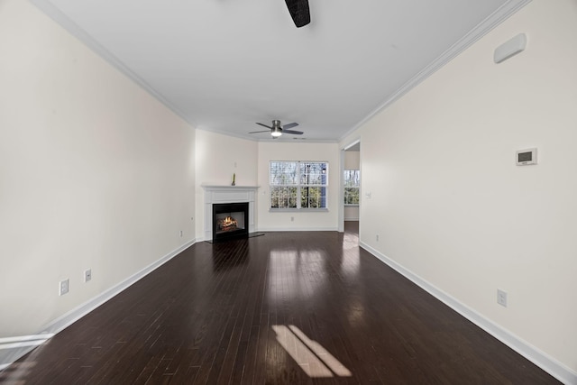 unfurnished living room featuring hardwood / wood-style floors, ceiling fan, and crown molding