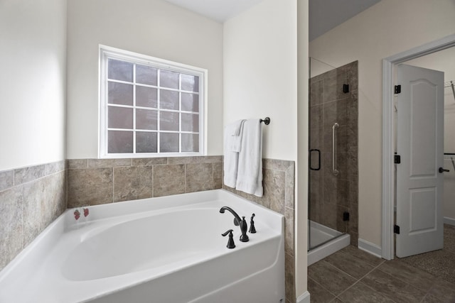 bathroom featuring tile patterned floors and shower with separate bathtub