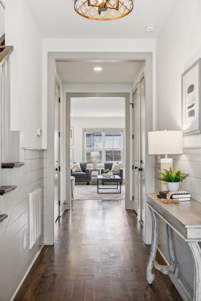 corridor with dark hardwood / wood-style flooring