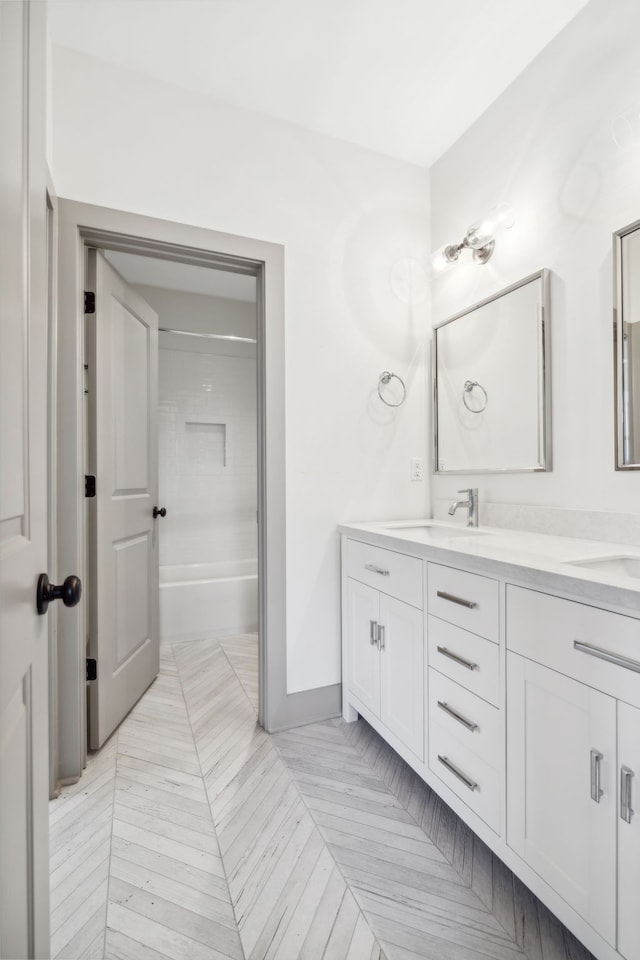 bathroom featuring shower / washtub combination and vanity