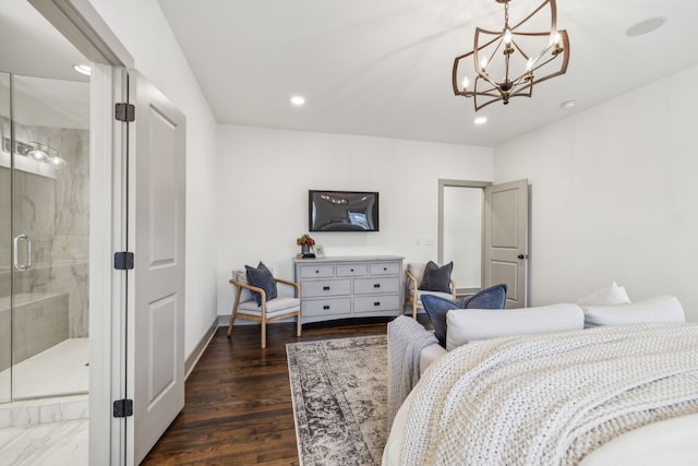 bedroom featuring connected bathroom, dark wood-type flooring, and a notable chandelier