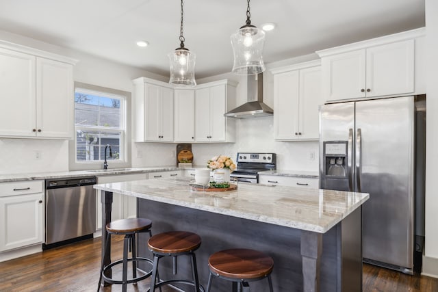 kitchen featuring white cabinets, wall chimney range hood, sink, dark hardwood / wood-style floors, and appliances with stainless steel finishes