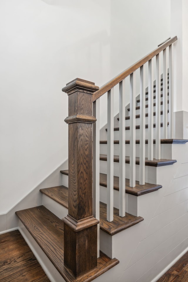 stairs featuring hardwood / wood-style floors