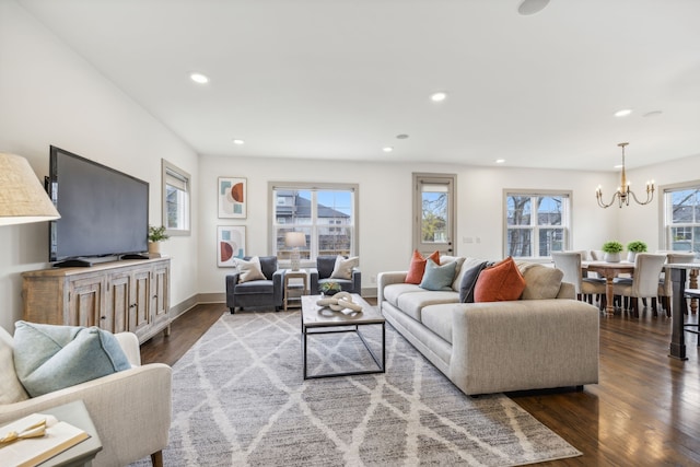 living room with dark hardwood / wood-style flooring and a chandelier