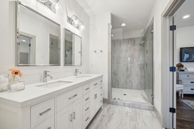 bathroom featuring hardwood / wood-style floors, vanity, and walk in shower