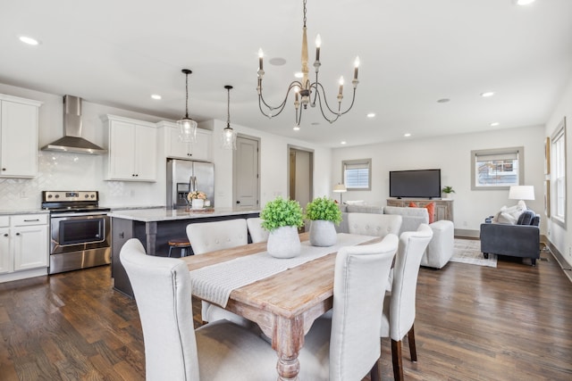 dining area with plenty of natural light, dark wood-type flooring, and an inviting chandelier