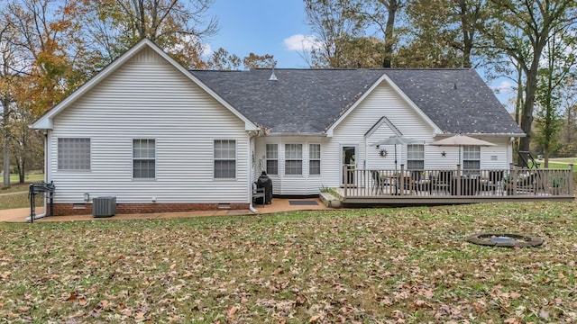 rear view of house featuring central AC unit, a deck, and a yard