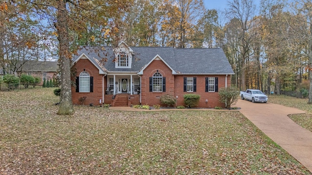 view of front of house featuring covered porch and a front yard