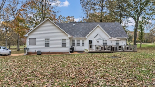 back of house with central AC, a yard, and a deck