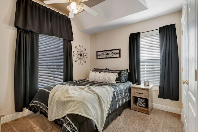 carpeted bedroom featuring vaulted ceiling and ceiling fan