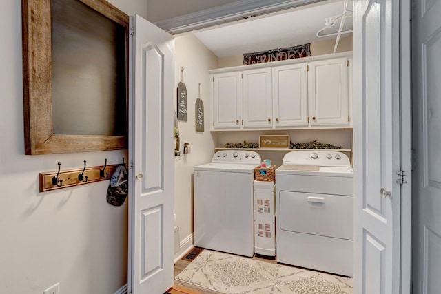 laundry area with washer and dryer and cabinets