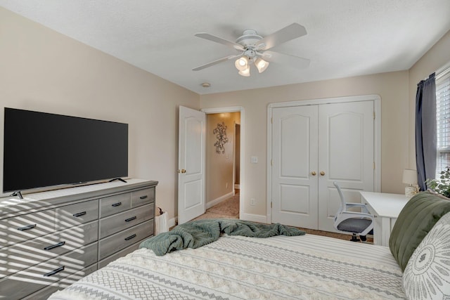 bedroom featuring ceiling fan, a closet, and light carpet