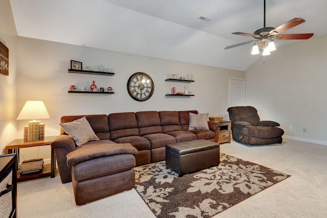 carpeted living room with ceiling fan and vaulted ceiling