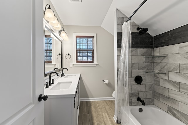 full bathroom with vanity, lofted ceiling, hardwood / wood-style flooring, toilet, and shower / bathtub combination with curtain