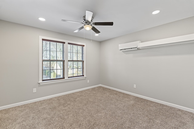 carpeted empty room with an AC wall unit and ceiling fan