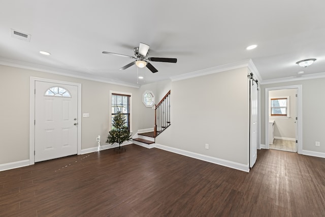 foyer with plenty of natural light, dark wood-type flooring, and ceiling fan