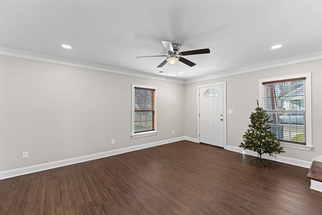 spare room with dark hardwood / wood-style flooring, ceiling fan, and ornamental molding