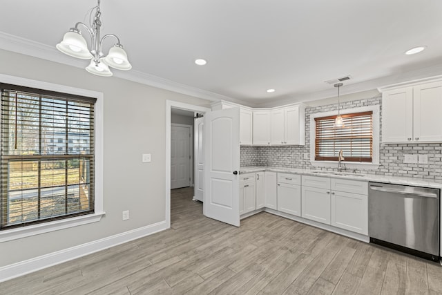 kitchen featuring white cabinetry, dishwasher, plenty of natural light, and sink