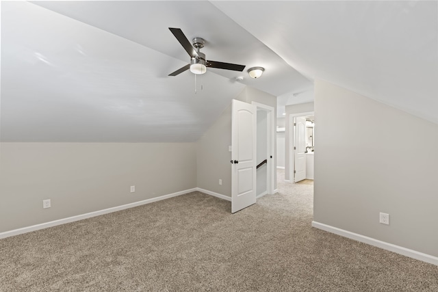 additional living space with ceiling fan, light carpet, and vaulted ceiling