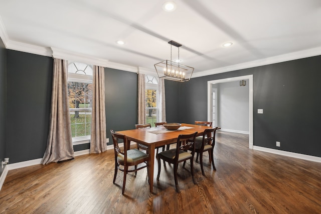 dining space with crown molding, dark wood-type flooring, and an inviting chandelier