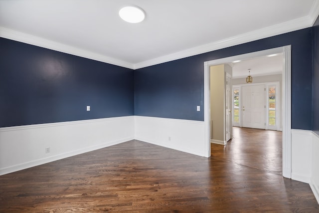 unfurnished room with dark hardwood / wood-style flooring and crown molding