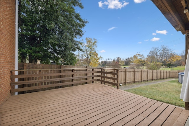 wooden terrace featuring a lawn