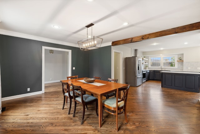 dining area with sink, ornamental molding, beam ceiling, dark hardwood / wood-style flooring, and a chandelier