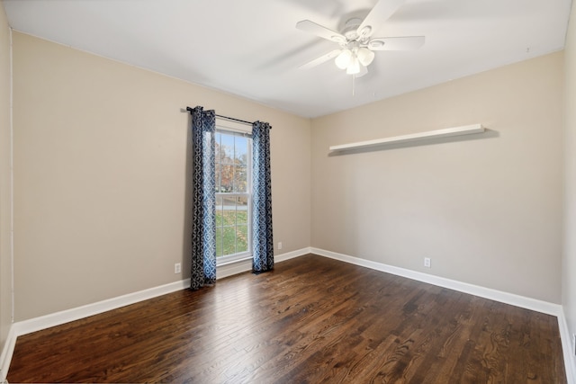 empty room with ceiling fan and dark hardwood / wood-style floors