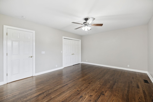 spare room with ceiling fan and dark wood-type flooring