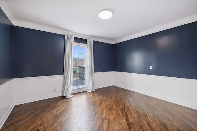 spare room with dark hardwood / wood-style flooring and ornamental molding