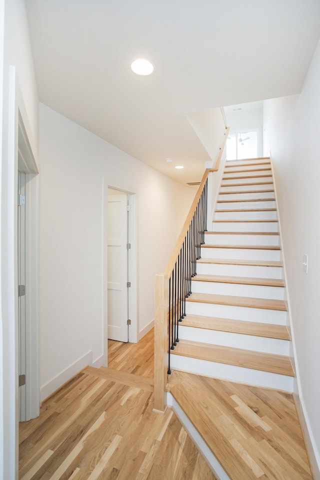 staircase featuring wood-type flooring