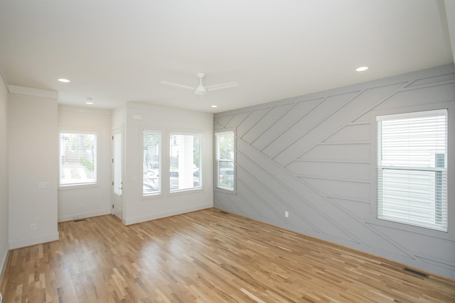 empty room with light hardwood / wood-style floors and ceiling fan