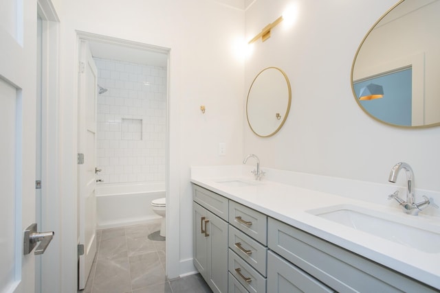 full bathroom with tile patterned flooring, vanity, tiled shower / bath combo, and toilet