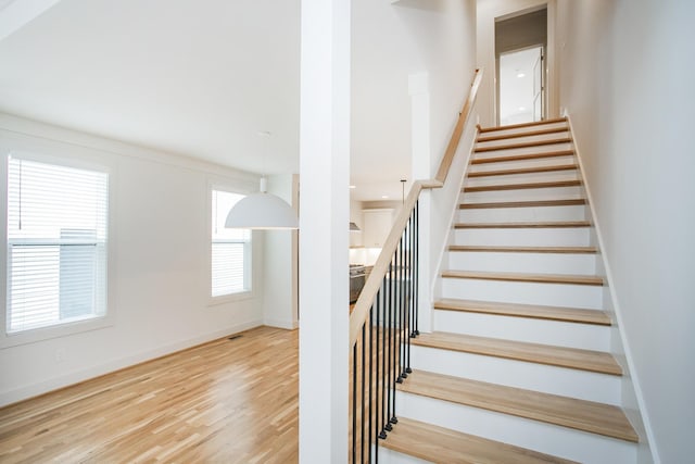 stairway featuring wood-type flooring