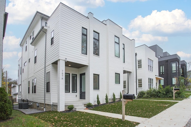 exterior space featuring a front yard and central air condition unit