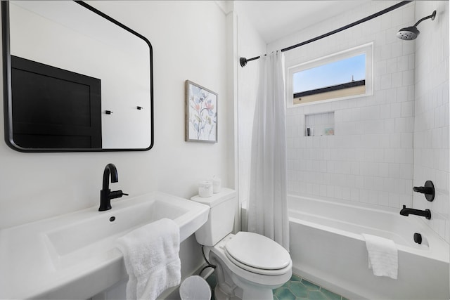 full bathroom with sink, shower / bathtub combination with curtain, and toilet