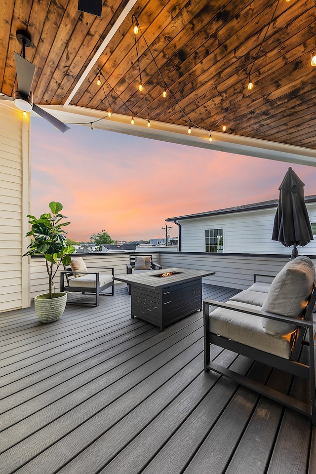 deck at dusk with an outdoor fire pit